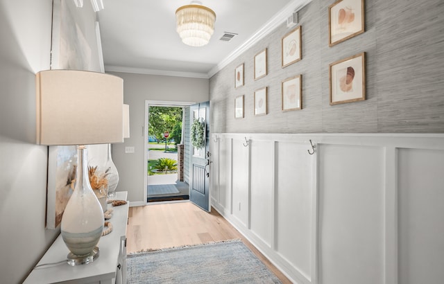 153 Glory Rd, Beaufort, SC 29906 - entryway featuring ornamental molding, wood finished floors, a wainscoted wall, a decorative wall, and wallpapered walls