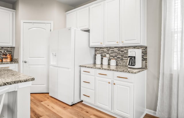 153 Glory Rd, Beaufort, SC 29906 - kitchen featuring white fridge with ice dispenser, light wood-type flooring, tasteful backsplash, and white cabinets