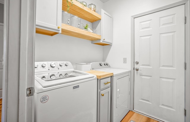 153 Glory Rd, Beaufort, SC 29906 - laundry area featuring cabinet space, washing machine and clothes dryer, and light wood-type flooring