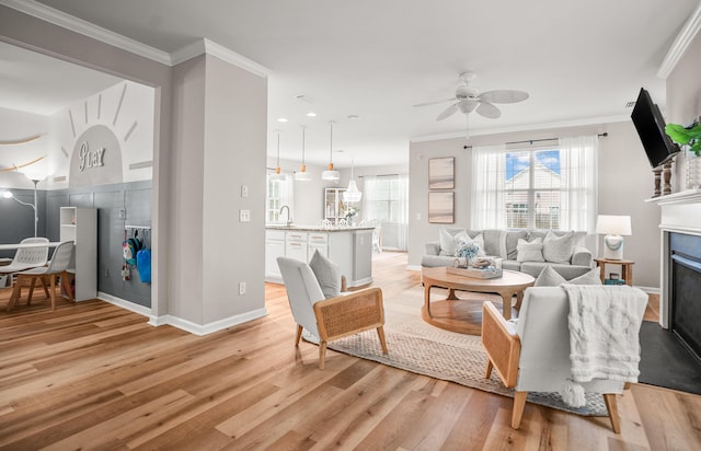 153 Glory Rd, Beaufort, SC 29906 - living room with a ceiling fan, light wood-style floors, a fireplace, and ornamental molding