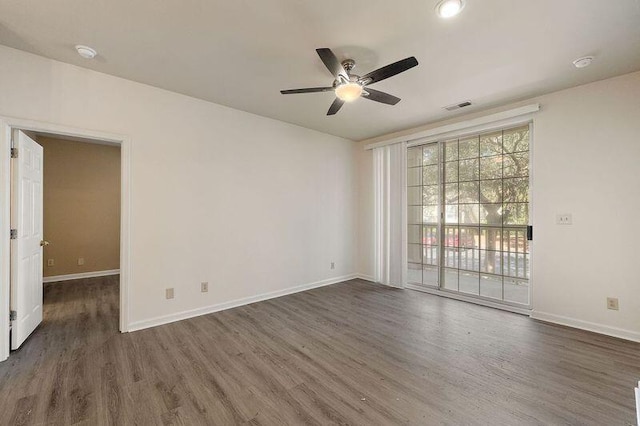 unfurnished room with visible vents, ceiling fan, baseboards, and wood finished floors