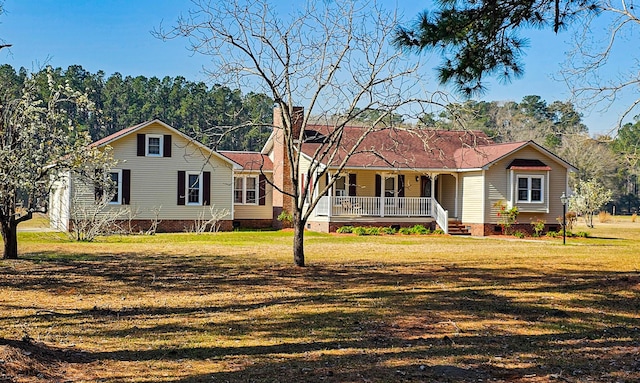 view of front of house with a porch, a chimney, a front yard, and crawl space