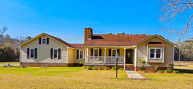 view of front of property featuring a porch, a front yard, and a chimney