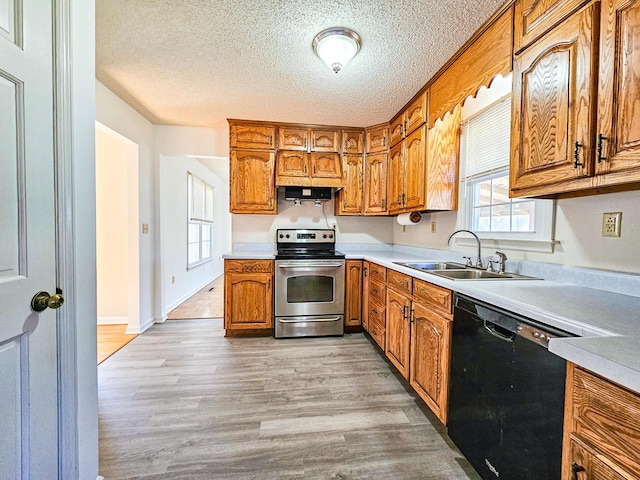 kitchen with stainless steel electric stove, brown cabinets, black dishwasher, and a sink