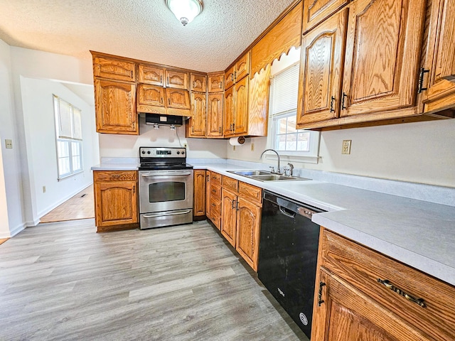 kitchen with a sink, electric range, black dishwasher, and brown cabinetry