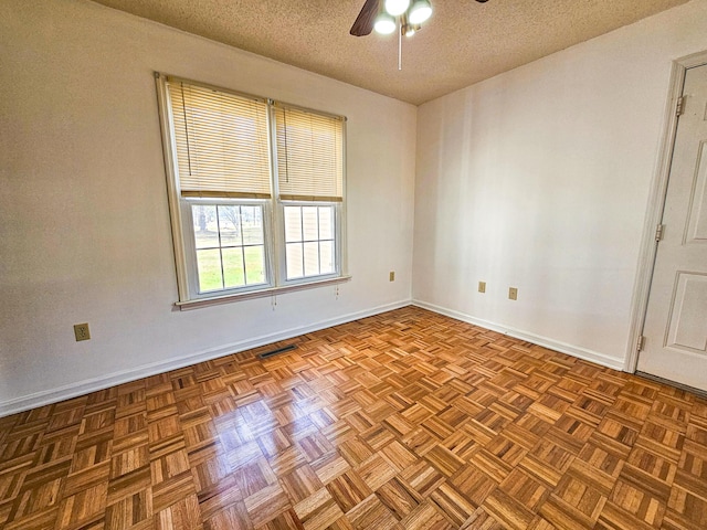 unfurnished room with a ceiling fan, baseboards, and a textured ceiling