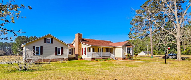 back of house with crawl space, a lawn, a porch, and a chimney