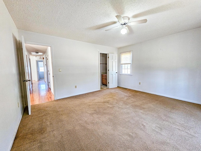 interior space featuring a textured ceiling, baseboards, and ceiling fan