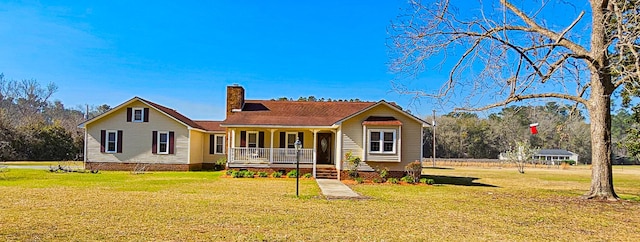 view of front facade featuring a chimney, a porch, and a front lawn