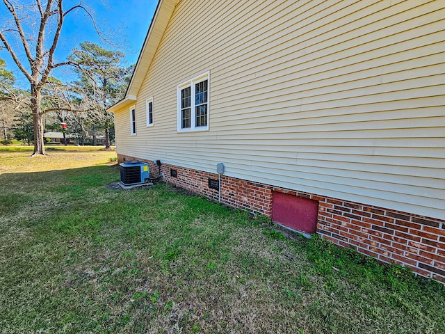 view of home's exterior with a yard, central AC, and crawl space