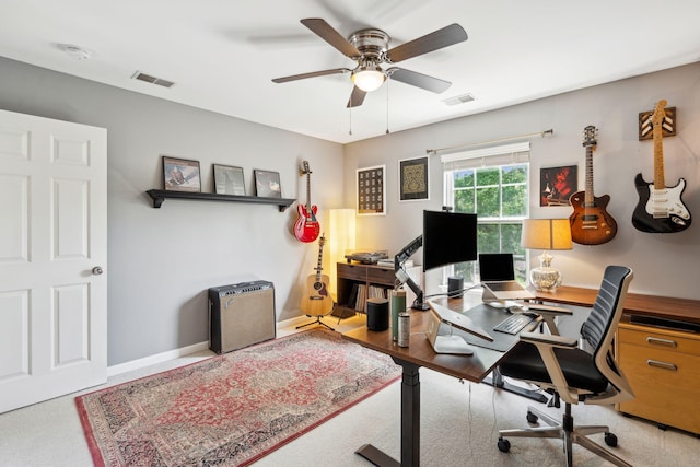 office space featuring ceiling fan and baseboards