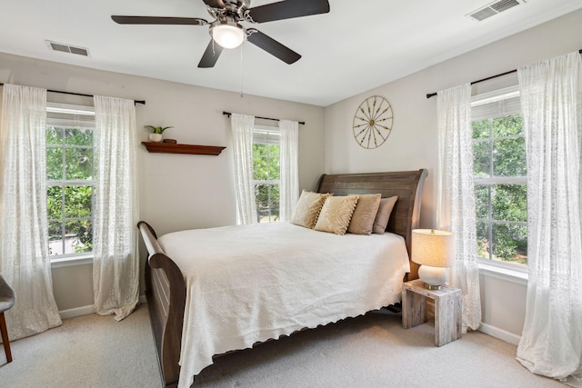 carpeted bedroom with baseboards and a ceiling fan