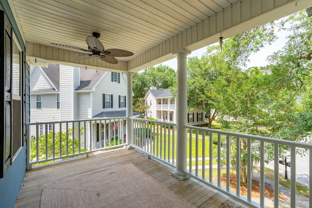 wooden terrace featuring a ceiling fan and a residential view