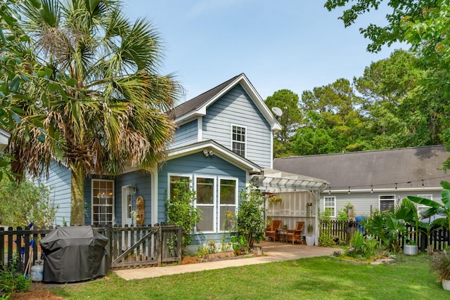 rear view of house featuring a pergola and a patio