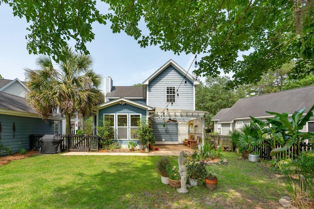 back of house with a pergola and a patio
