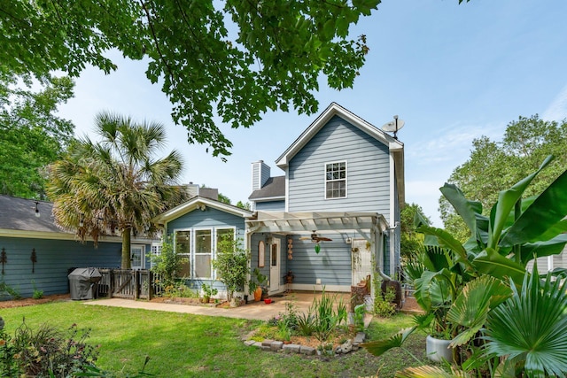 rear view of house featuring a pergola, a patio, and a gate