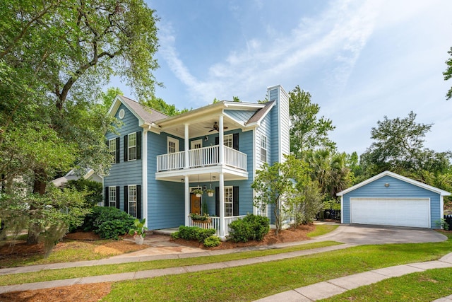 traditional home featuring a balcony, a ceiling fan, a chimney, a garage, and covered porch