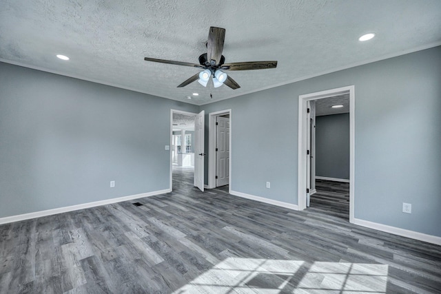 interior space with baseboards, ornamental molding, dark wood-style flooring, a textured ceiling, and recessed lighting