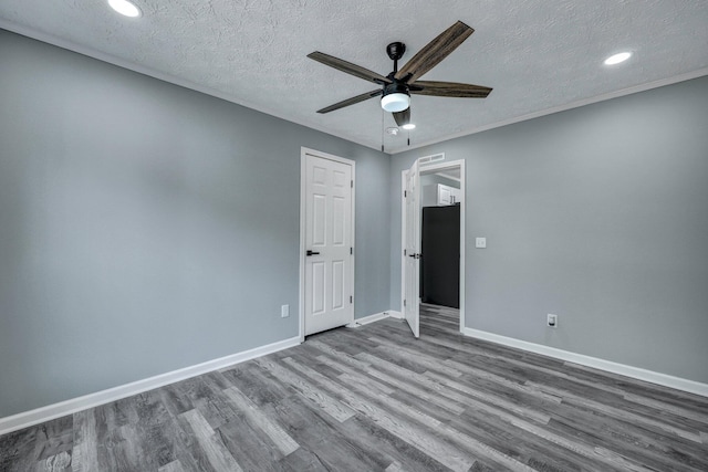 unfurnished room featuring ceiling fan, a textured ceiling, recessed lighting, wood finished floors, and baseboards