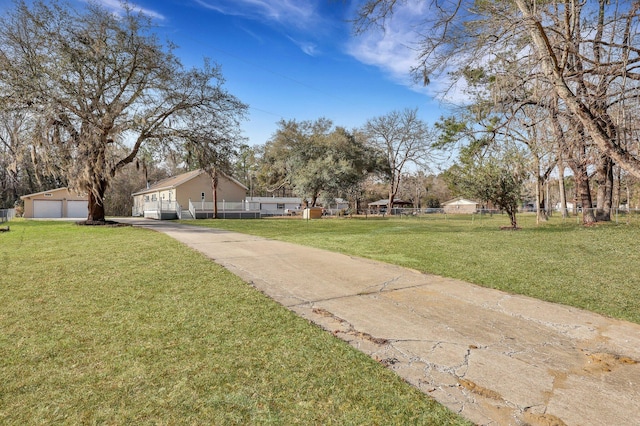 view of yard featuring a fenced front yard and a detached garage