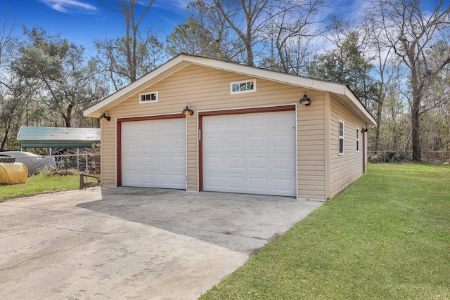 detached garage featuring fence