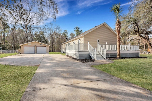 view of side of property featuring a wooden deck, a detached garage, a lawn, and an outdoor structure