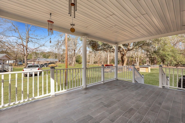 wooden terrace featuring a yard