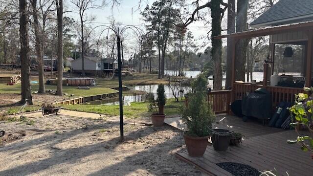 view of yard featuring a deck with water view