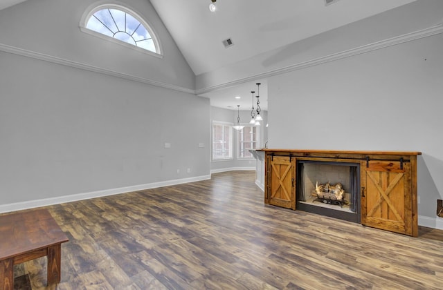 unfurnished living room featuring dark hardwood / wood-style floors and high vaulted ceiling