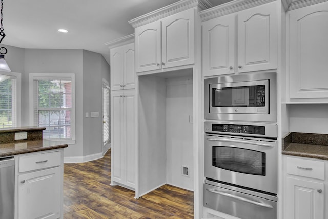 kitchen with dark hardwood / wood-style flooring, dishwashing machine, dark stone countertops, white cabinetry, and stainless steel microwave