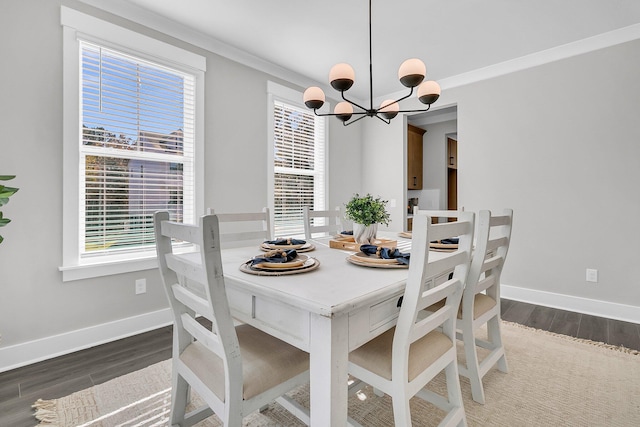 dining room with crown molding, dark hardwood / wood-style flooring, and a chandelier