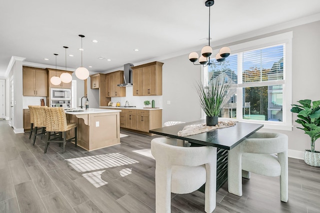 dining space with hardwood / wood-style floors, crown molding, and a notable chandelier