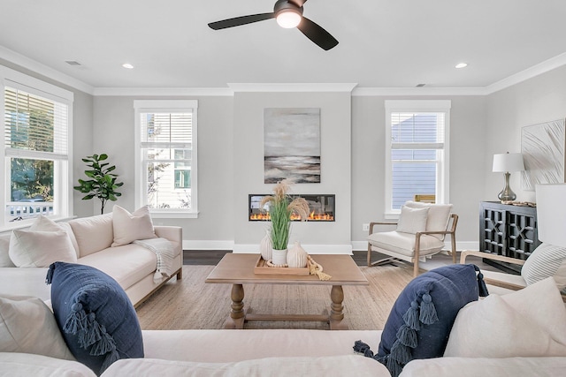 living room featuring crown molding, wood-type flooring, and ceiling fan