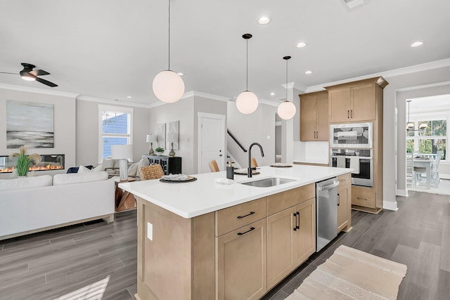 kitchen with a kitchen island with sink, sink, appliances with stainless steel finishes, and light brown cabinets