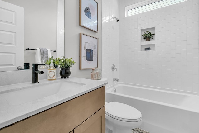 full bathroom featuring vanity, toilet, and tiled shower / bath combo