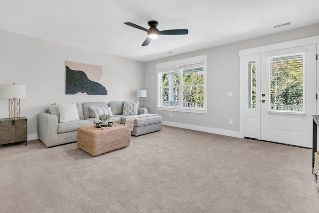 carpeted living room featuring ceiling fan