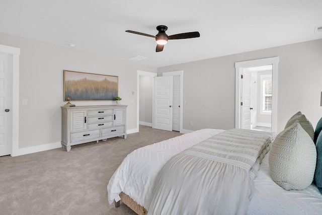 carpeted bedroom featuring connected bathroom and ceiling fan