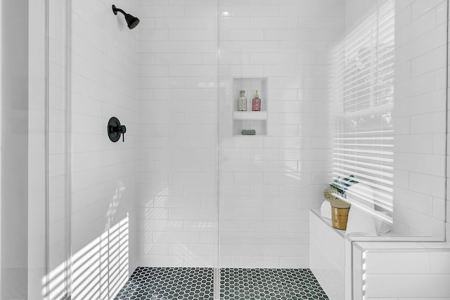 bathroom with tiled shower