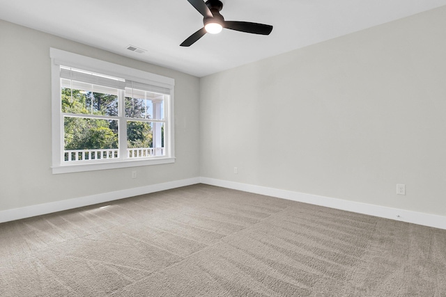 empty room featuring carpet floors and ceiling fan