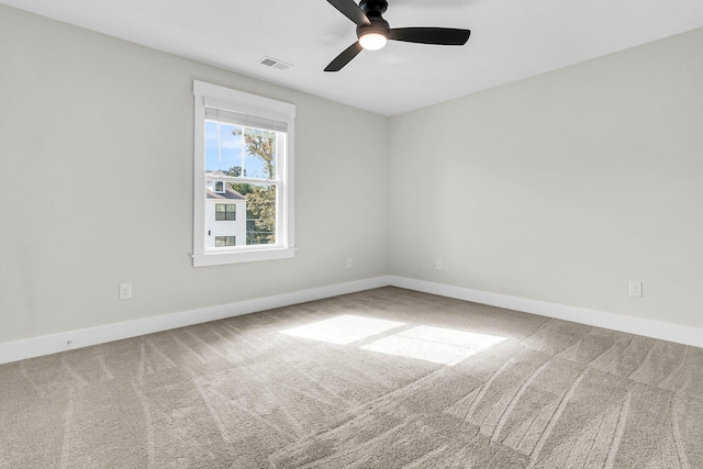 carpeted empty room featuring ceiling fan