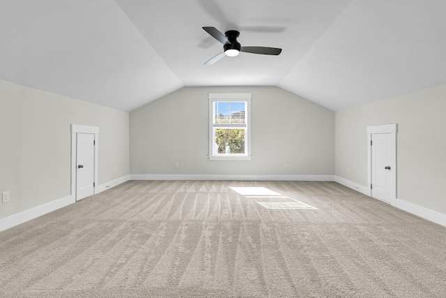 additional living space with lofted ceiling, light colored carpet, and ceiling fan