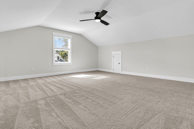 bonus room with lofted ceiling, light colored carpet, and ceiling fan