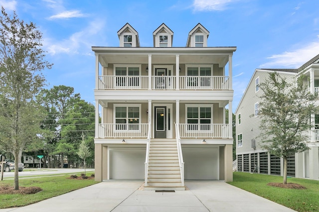 coastal home featuring a porch and a garage