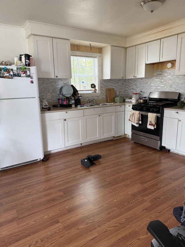 1255 Remount Rd, North Charleston, SC 29406 - kitchen with freestanding refrigerator, stainless steel range with gas cooktop, crown molding, backsplash, and white cabinetry
