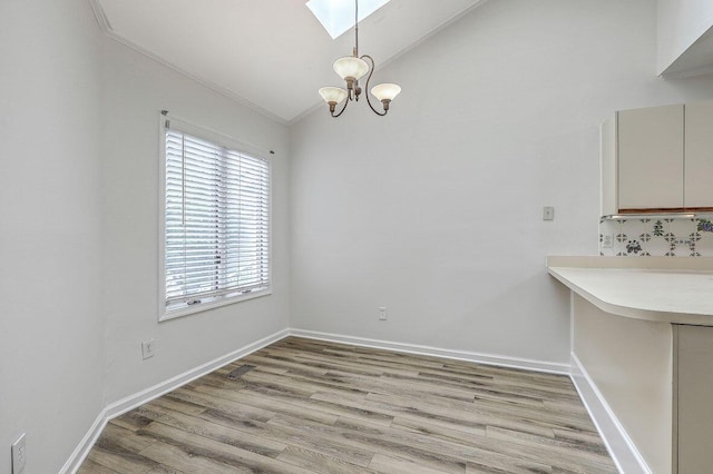 638 Harbor Creek Pl Unit 19, Charleston, SC 29412 - unfurnished dining area with vaulted ceiling, a skylight, light wood-style flooring, and a chandelier