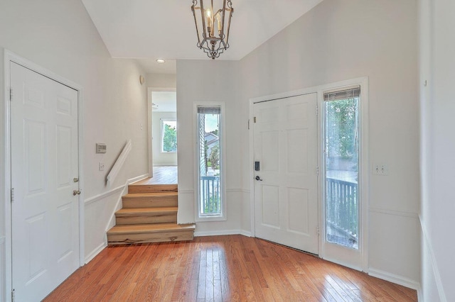 638 Harbor Creek Pl Unit 19, Charleston, SC 29412 - entryway with light wood-type flooring, stairway, vaulted ceiling, and a chandelier