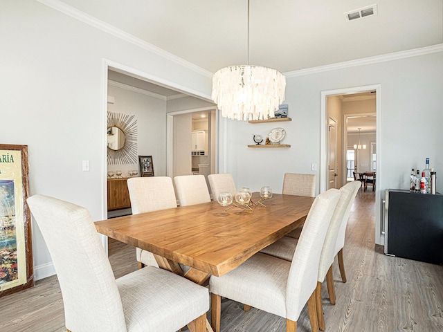 2064 Parish House Cir, Johns Island, SC 29455 - dining space with visible vents, ornamental molding, a notable chandelier, and light wood finished floors