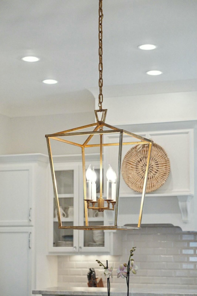 interior details with recessed lighting, decorative backsplash, glass insert cabinets, and white cabinets