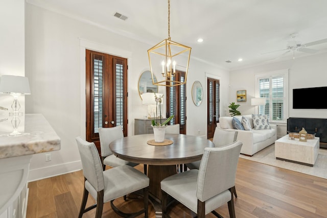 dining area featuring visible vents, ceiling fan with notable chandelier, recessed lighting, light wood-style floors, and baseboards