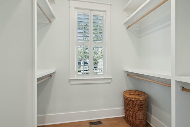 spacious closet featuring visible vents and wood finished floors